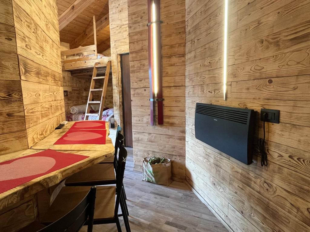 a room with a bed and a tv on a wall at Appartamento Grande Cervino - Il Lupo Affitta in Antey-Saint-André