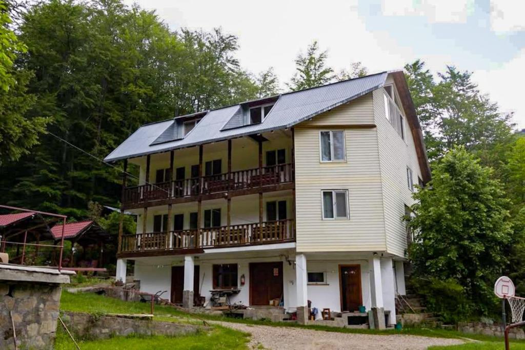 a house with a solar roof on top of it at 14 Scaune Casoca Tudose in Caşoca
