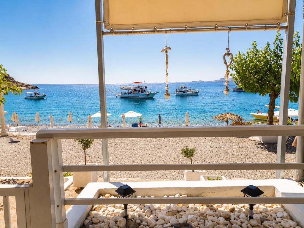 a view of a beach with boats in the water at Whisper wave in Haraki
