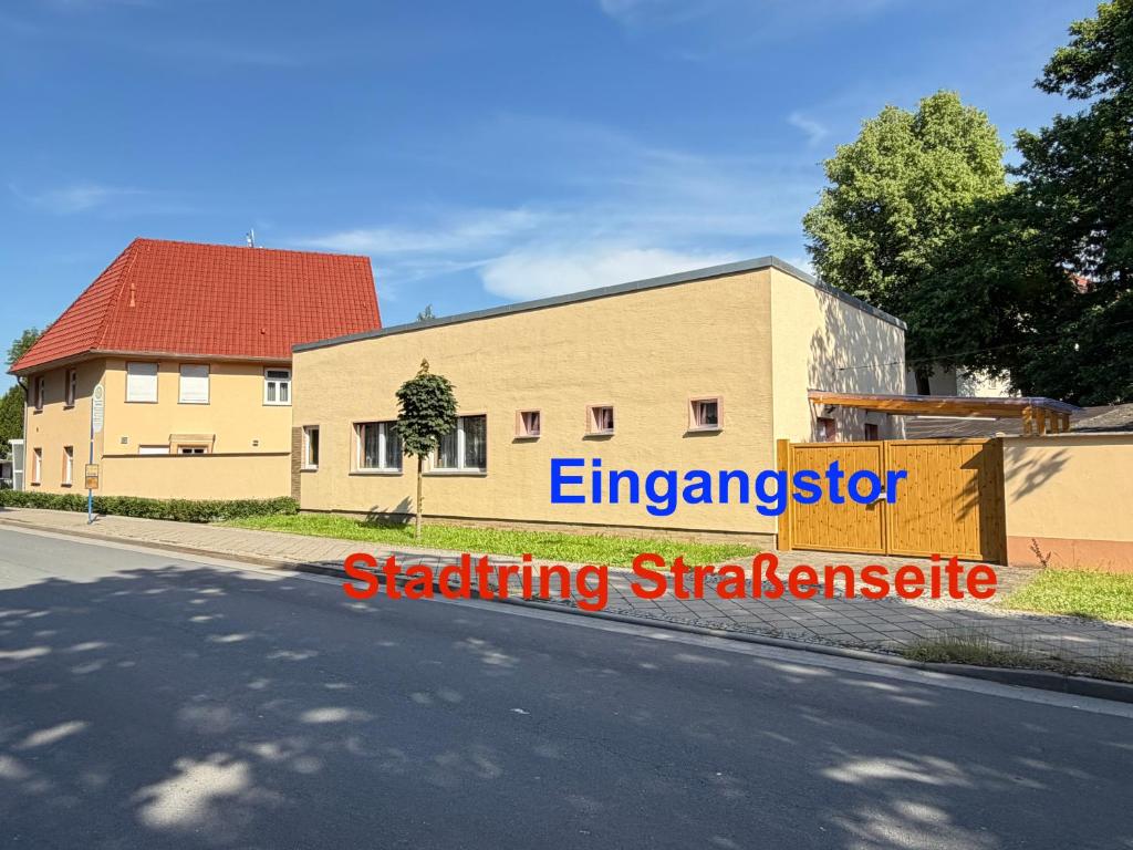 a building with a sign on the side of a street at Kim Ferienwohnung B in Sömmerda