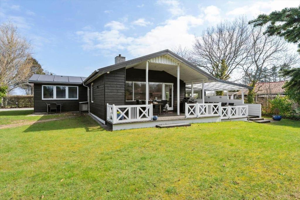 a small house with a porch and a yard at 30392-Odder-Delfinvej-5 in Odder