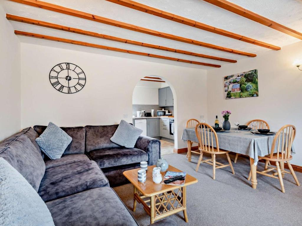 a living room with a couch and a table at 2 Bed in Dereham oc-92392 in Whissonsett