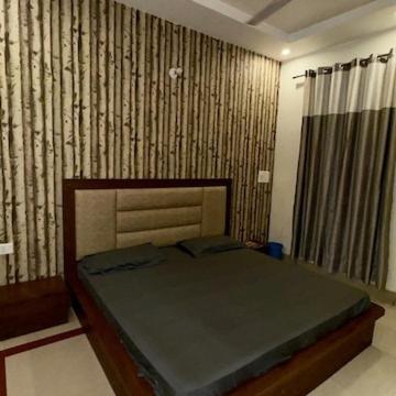 a bedroom with a bed in a room at Hotel Lucifer by Evening Star in Bathinda