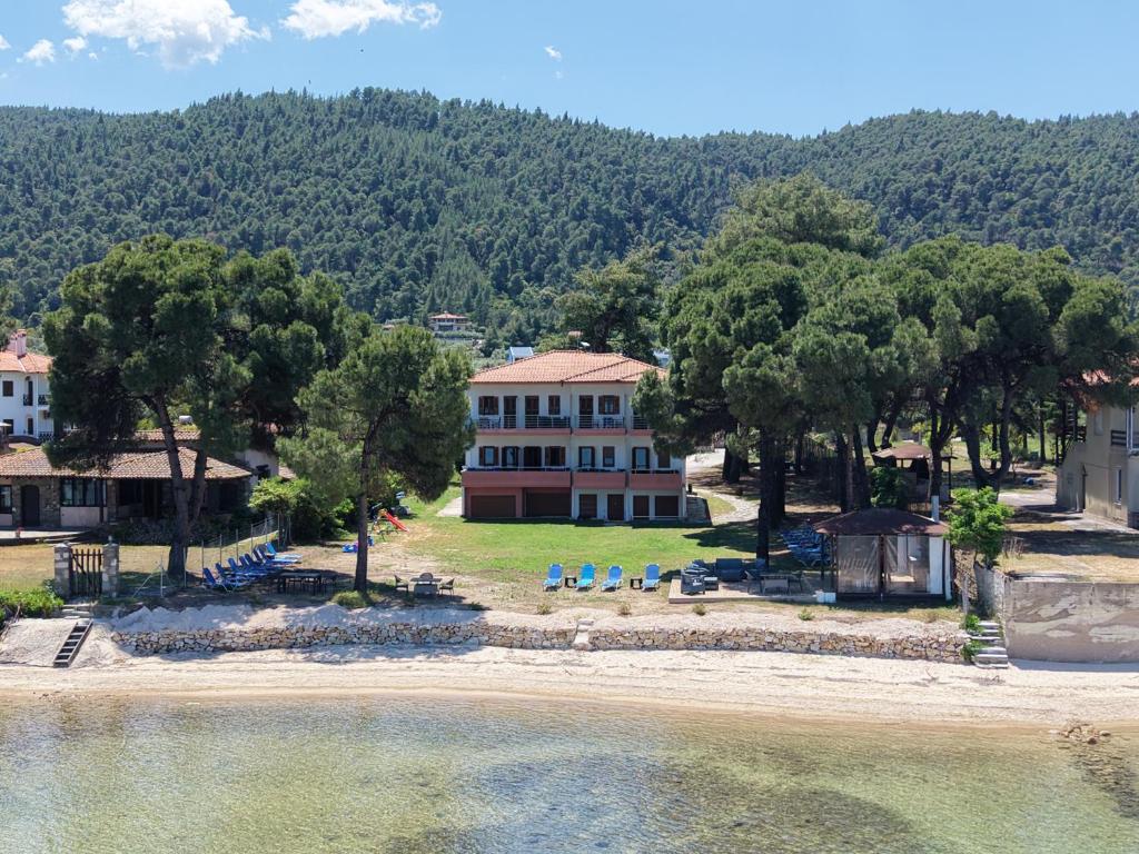 an aerial view of a house next to a body of water at Studios Efi beach in Vourvourou