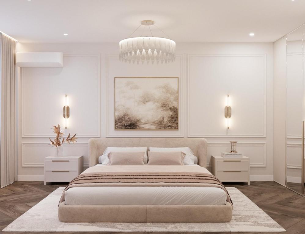 a white bedroom with a large bed and a chandelier at Lutsk Elegance Apartment in Lutsk