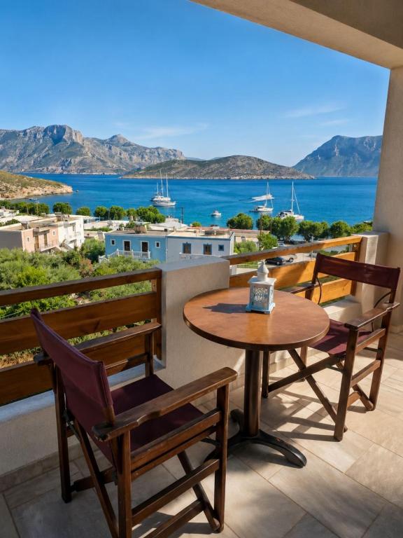 a table and chairs on a balcony with a view of the ocean at Emporios Blue Apartment in Emborios
