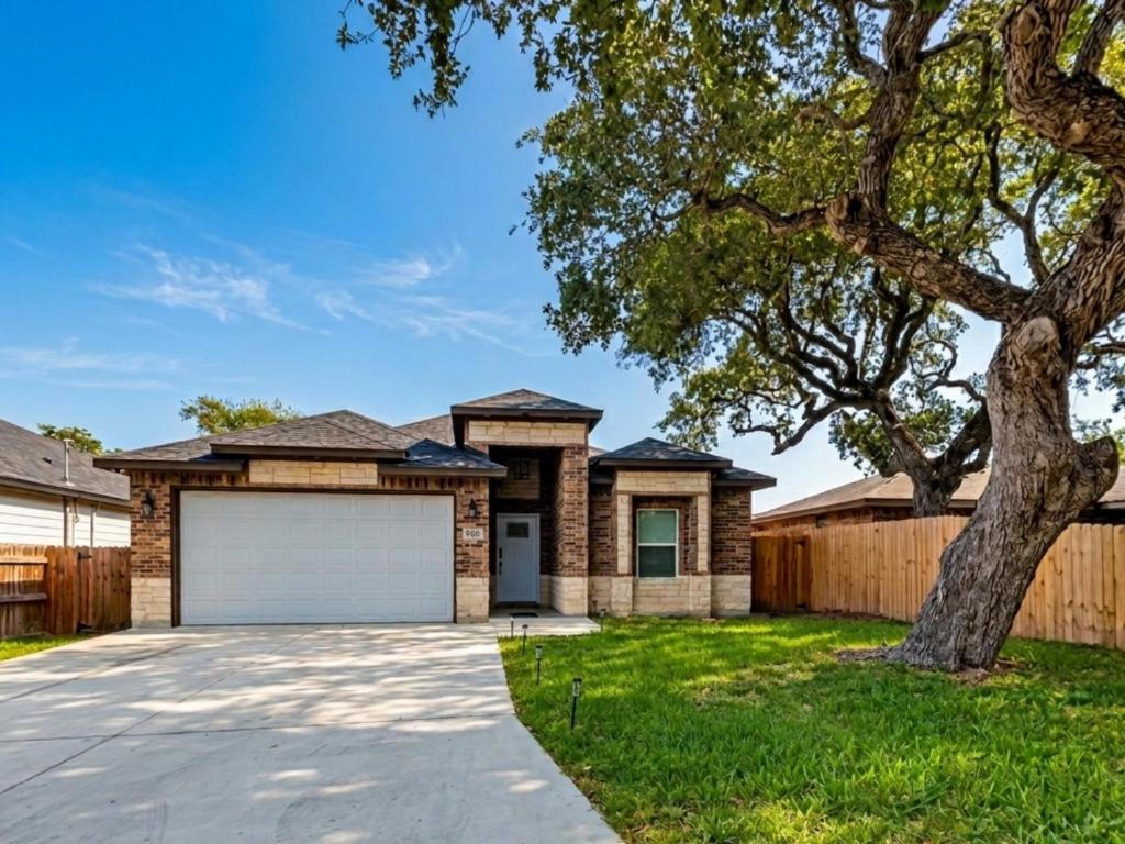 a house with a garage and a fence at Ferrymans Landing in Aransas Pass
