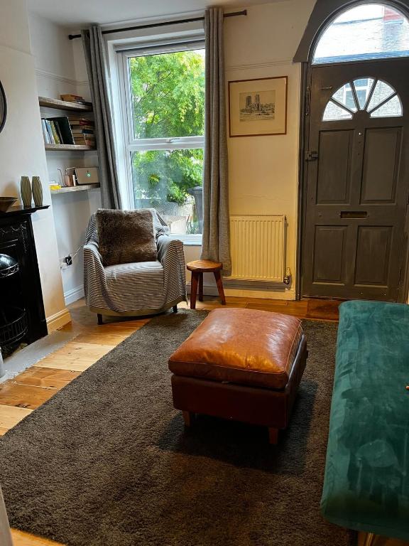 a living room with a chair and a door at Mansfield House in Norwich