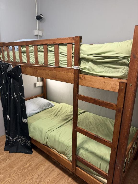 a couple of bunk beds in a room at 5 Minutes Away Airport Lodge in Putatan