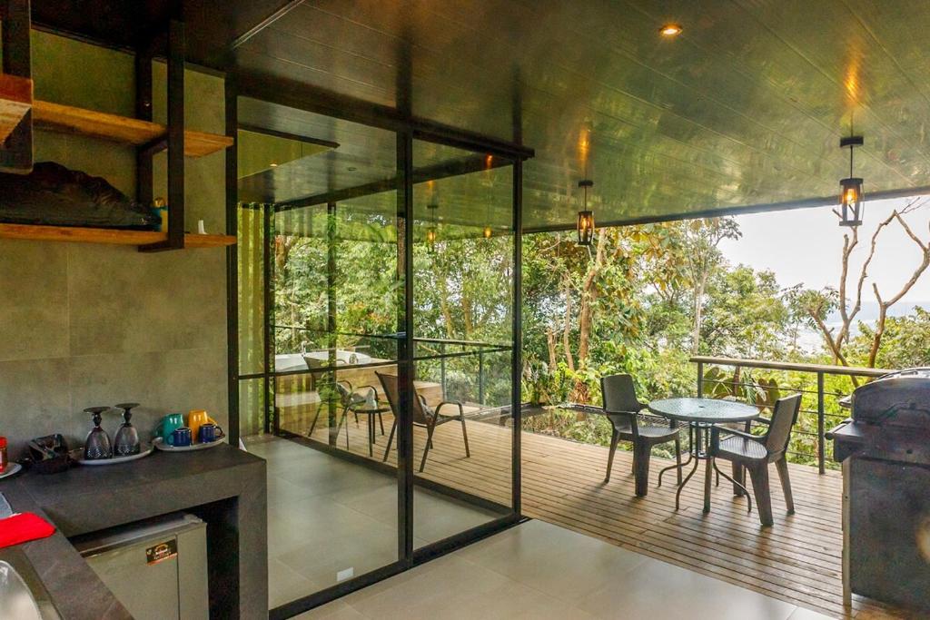 a kitchen with a deck with a table and chairs at Itawa ecoparque in Villavicencio