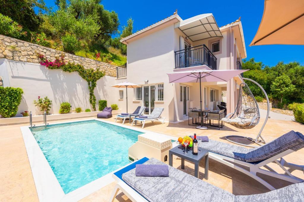 a villa with a swimming pool and a house at Villa Dimi in Tsilivi