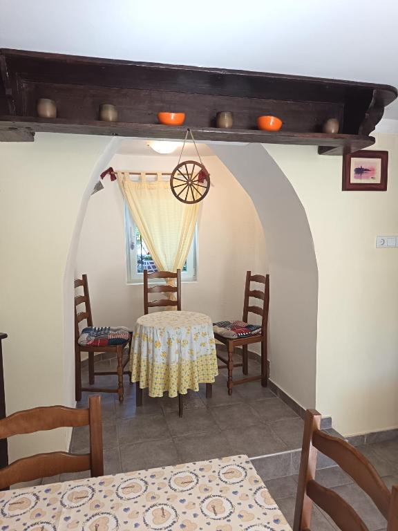 a dining room with a table and chairs at Apartman sa suncem in Beli