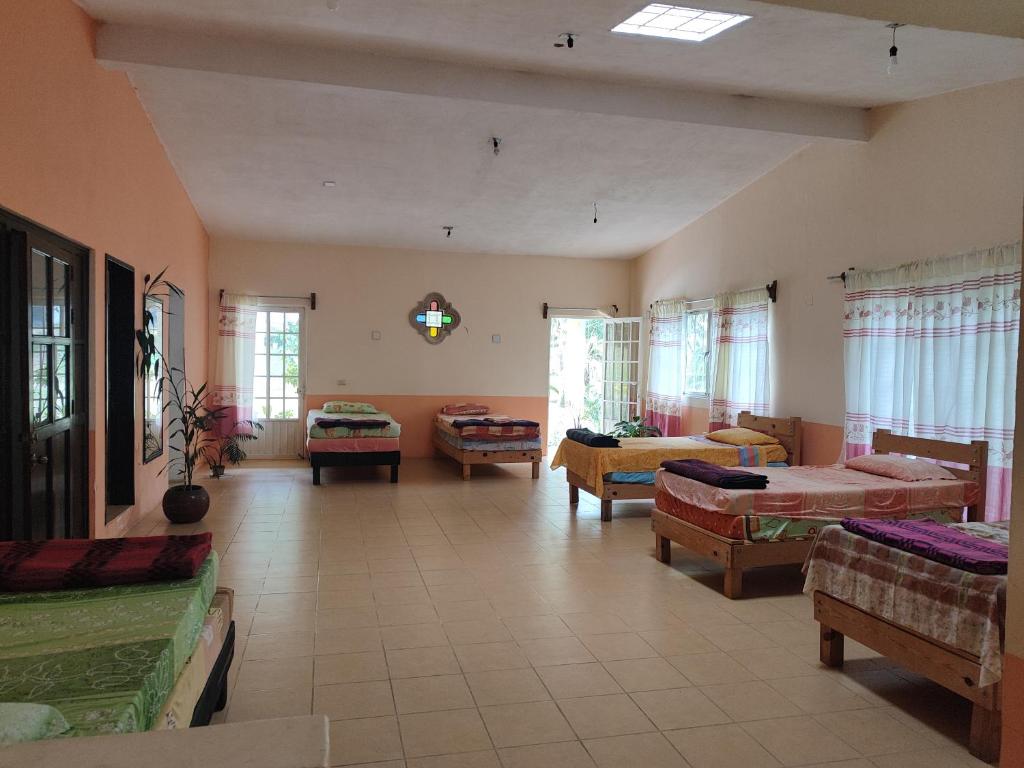 a large living room with beds and a couch at EL Jardin De Los Anturios in Xico