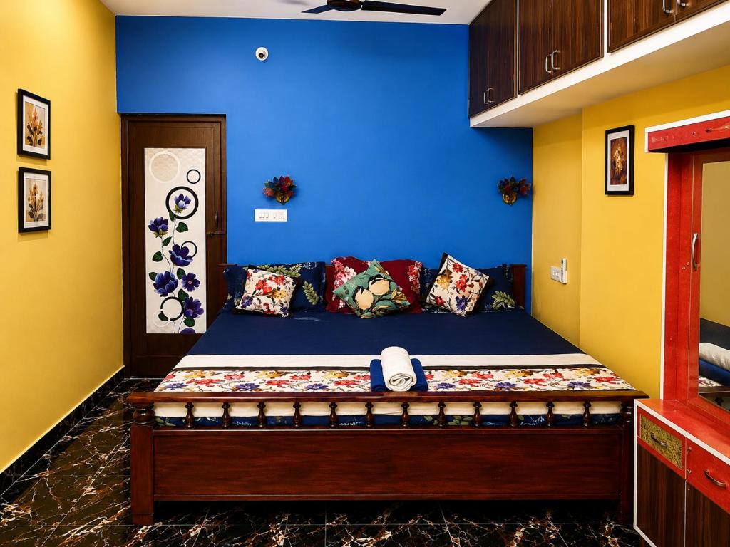 a bedroom with a bed with a phone on it at La Baie Homestay in Pondicherry