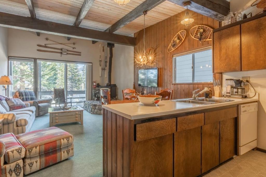 a kitchen with a sink and a living room at Pet Friendly 2B2B on Lake Basins Bike Path! in Mammoth Lakes