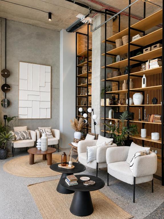 a living room with couches and tables and shelves at Studio 202 in Brno