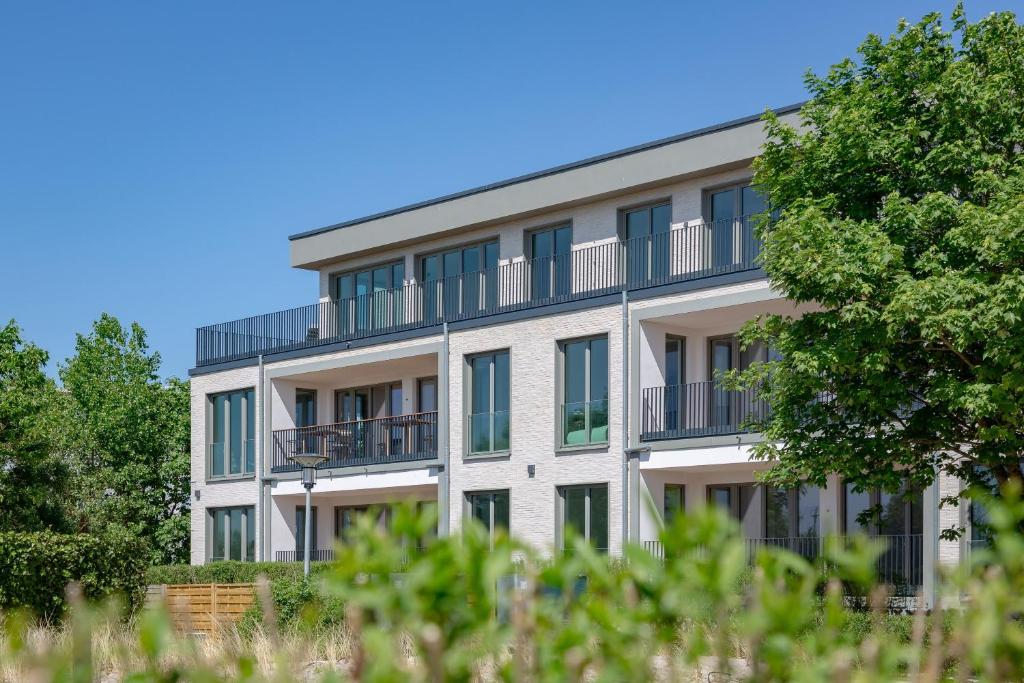 an apartment building with balconies and trees at Ferienwohnung Seaside App 9 List auf Sylt in List