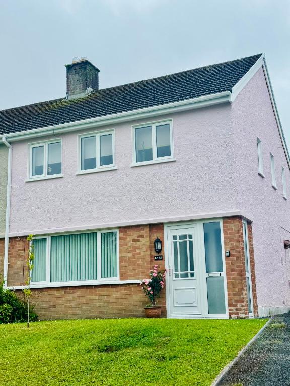 a large brick house with a white door at St Martin’s view in Haverfordwest