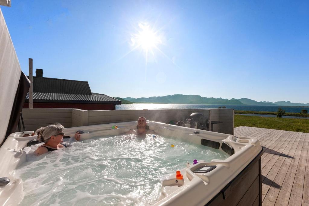two children playing in a jacuzzi bathtub at Roksoy for rent in Sortland