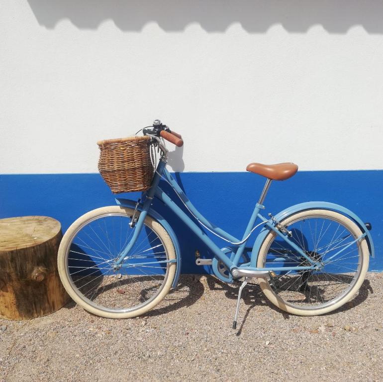 a blue bike with a basket parked next to a wall at Typical Alentejo House in Mora