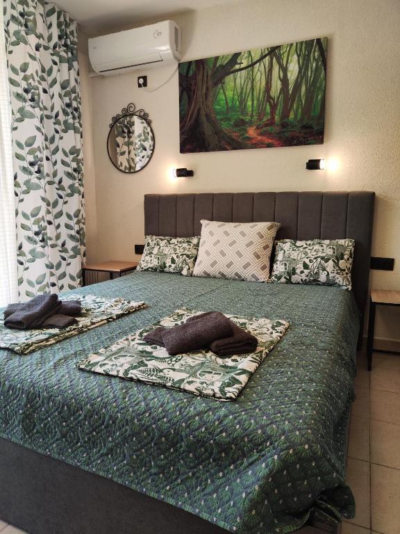 a bedroom with a bed with two pillows on it at Студио Forest, к-с Нестинарка in Tsarevo