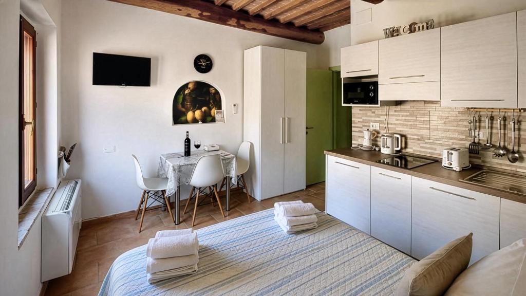 a kitchen with a table and a dining room at The Optimist's House in Staggia