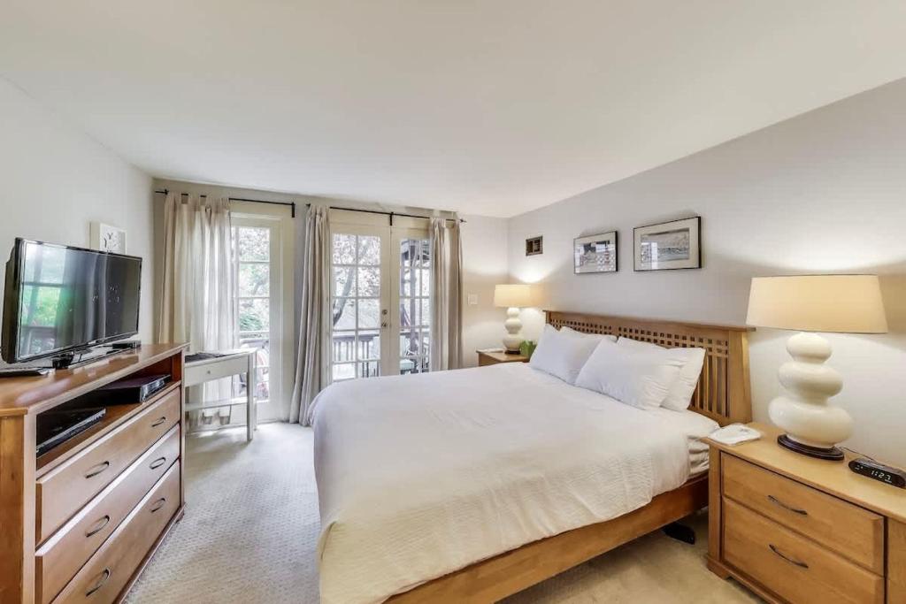 a bedroom with a large bed and a television at Quiet Studio near Glen Park in San Francisco
