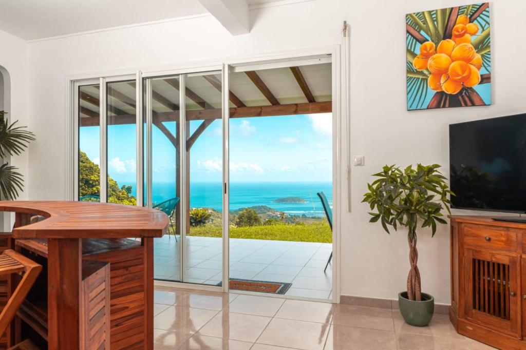 a living room with a view of the ocean at Villa Syleone in Sainte-Marie