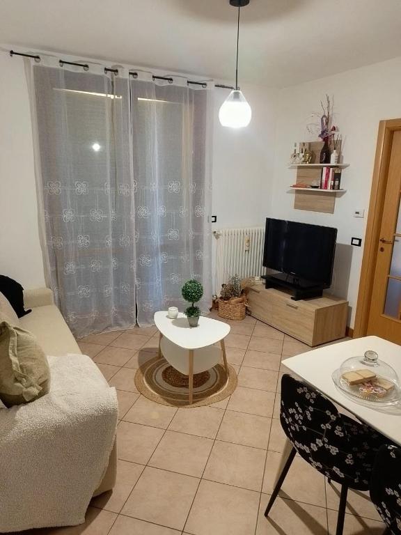 a living room with a couch and a tv at Pretty home near station & Free Parking in Castel Bolognese