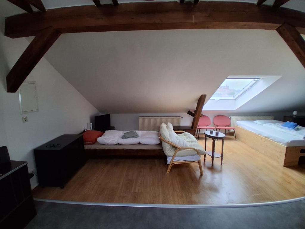 a attic room with a bed and a table and a chair at Mittendrin in Stendal