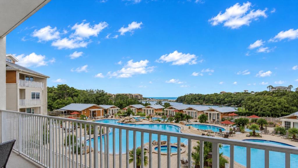 a balcony with a view of the pool and resort at Sanctuary at Redfish 2115 by Newman-Dailey in Santa Rosa Beach