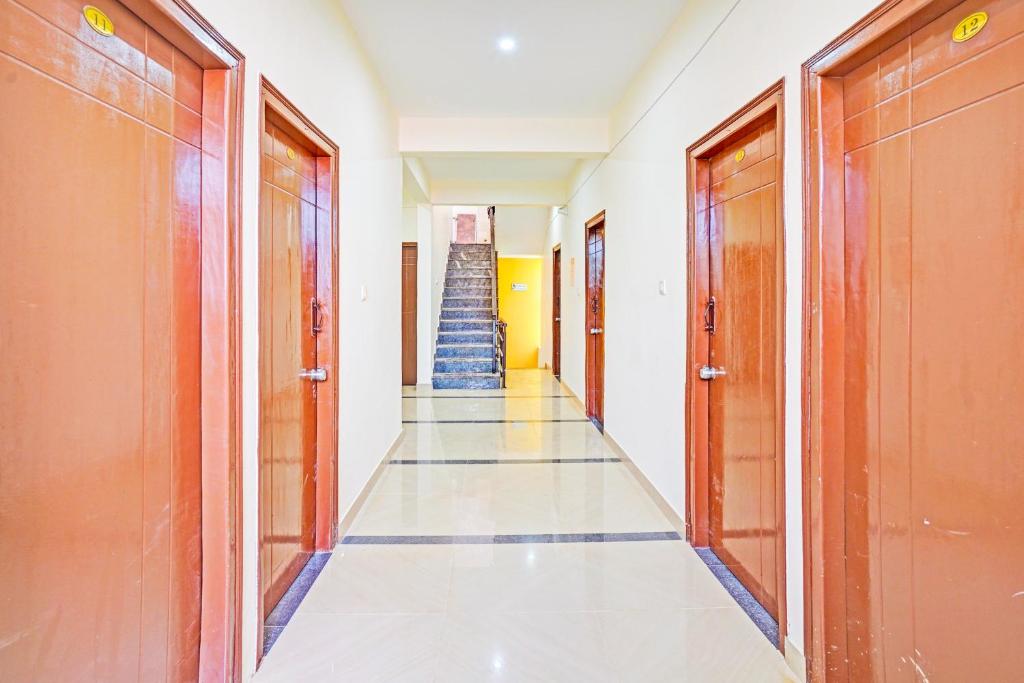 a hallway with a staircase in a building at Hotel O JK Blue Rock Comforts in Bangalore