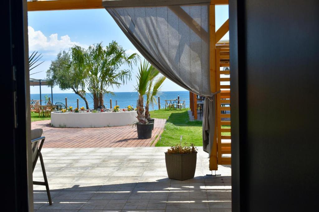 a room with a view of the ocean from a patio at Calliroe Sea View in Alexandroupoli