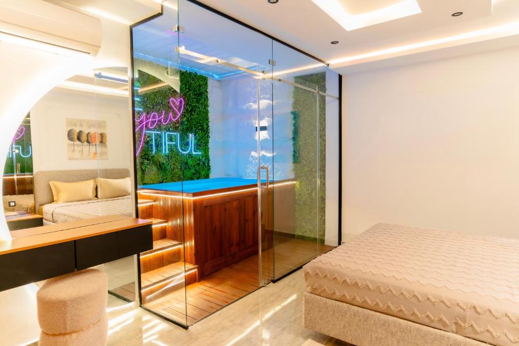 a bedroom with a bed and a glass wall at Liveable artwork in Sousse