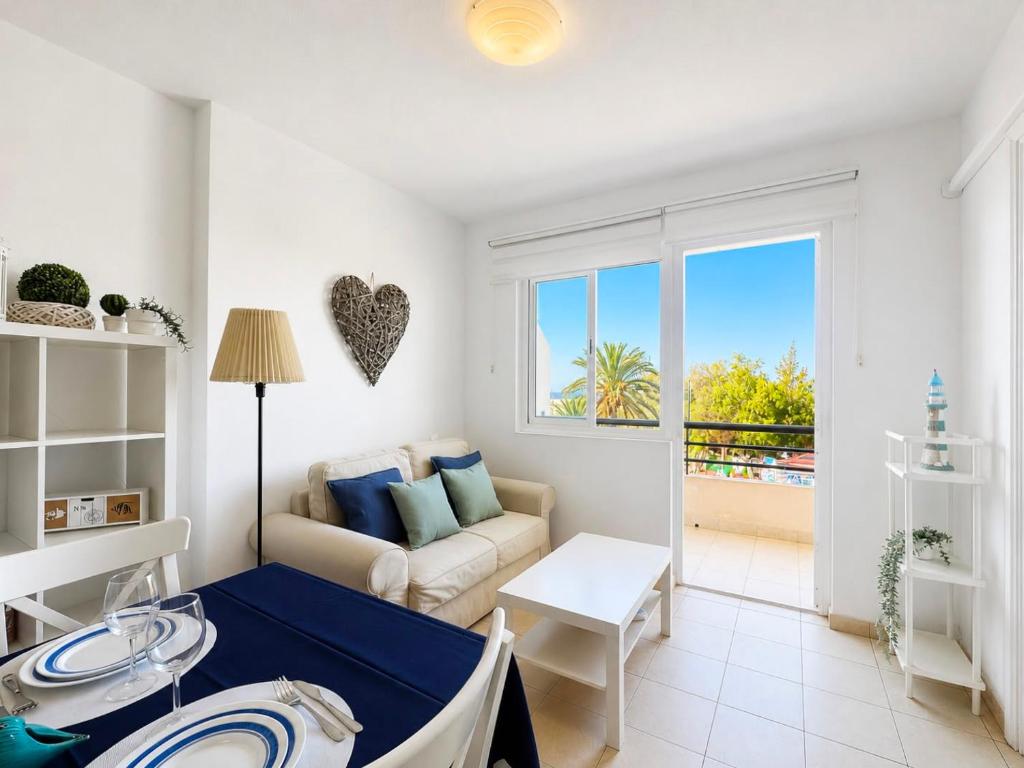 a living room with a couch and a table at Casa Sol de Jandía in Morro del Jable