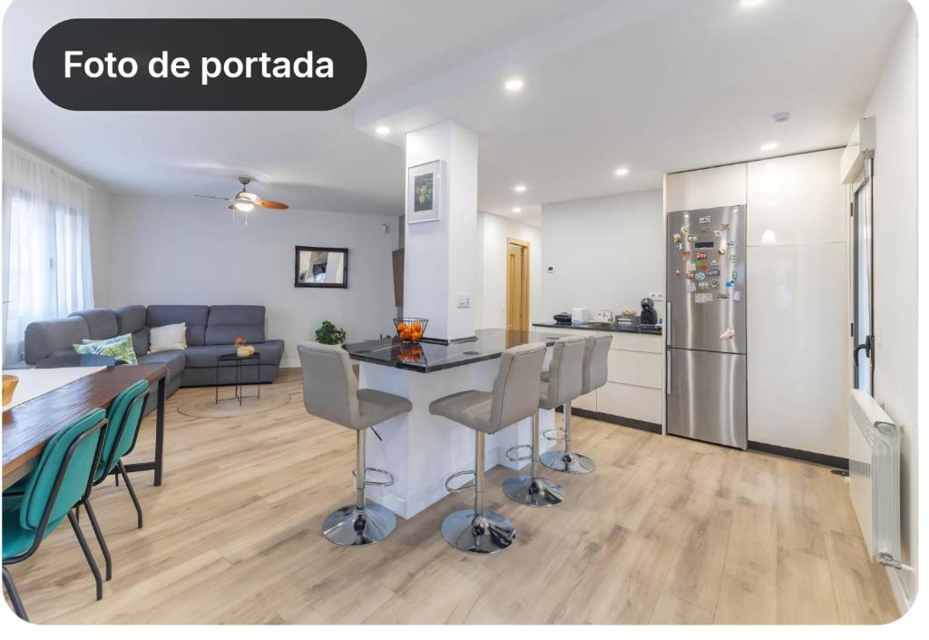 a kitchen and living room with a table and chairs at El Rincon La Roca in El Espinar