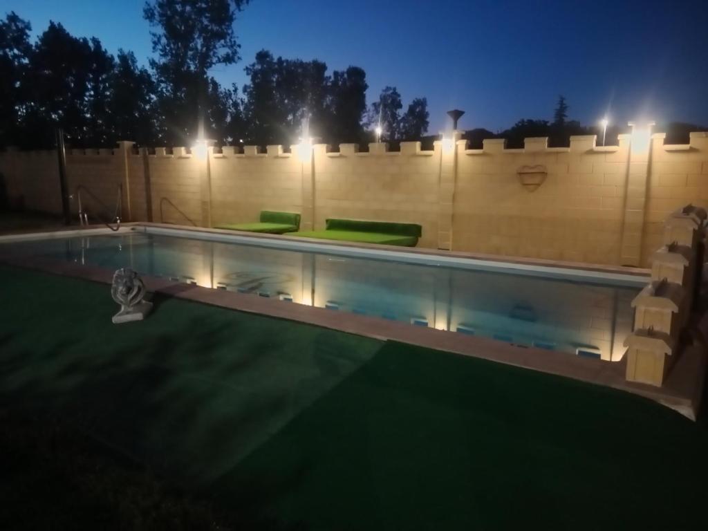 a swimming pool in a backyard at night at Remedios de Luna in Antimio de Arriba