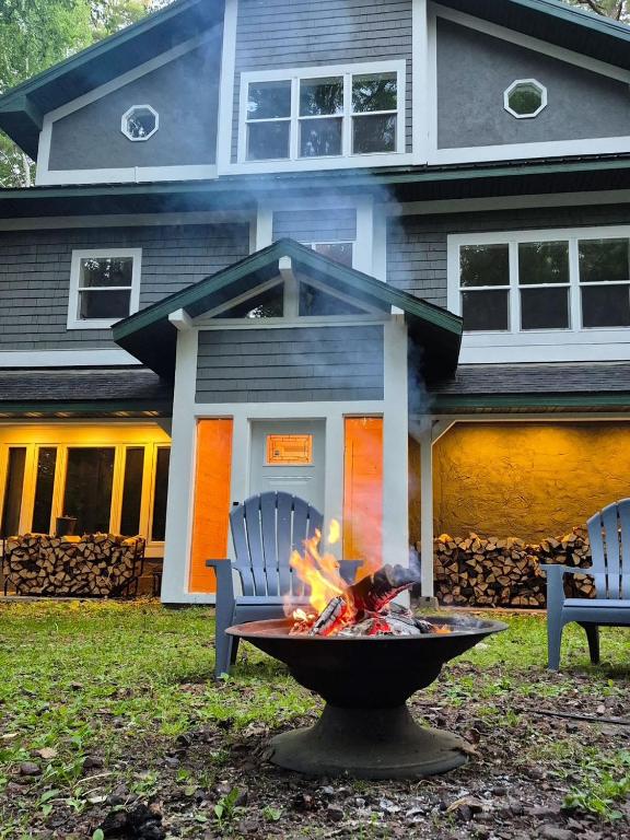 a fire pit in a yard in front of a house at CrossLake Getaway in Cross Lake