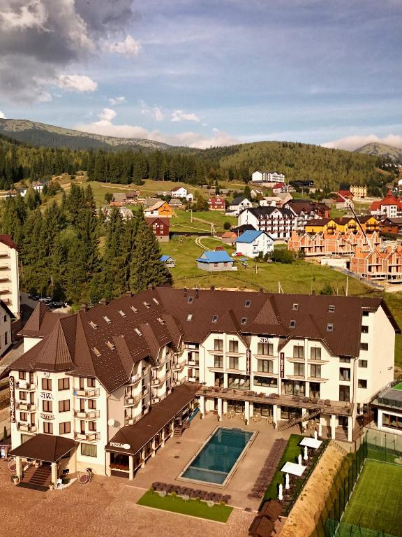 an aerial view of a building with a swimming pool at Continental SPA in Bukovel