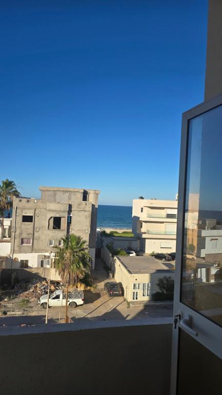 a view from the balcony of a building with the ocean at Appartement kantaoui in Sousse