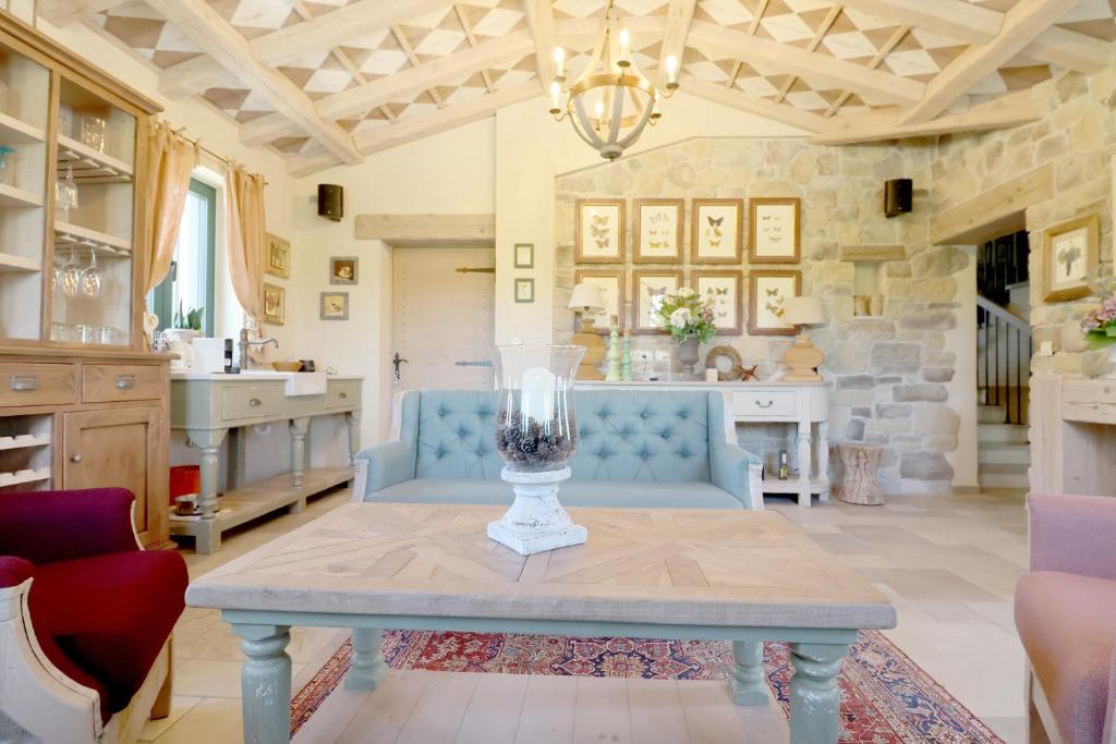 a living room with a blue couch and a table at Private Villa for 12 Peaceful Karst Escape in Dutovlje