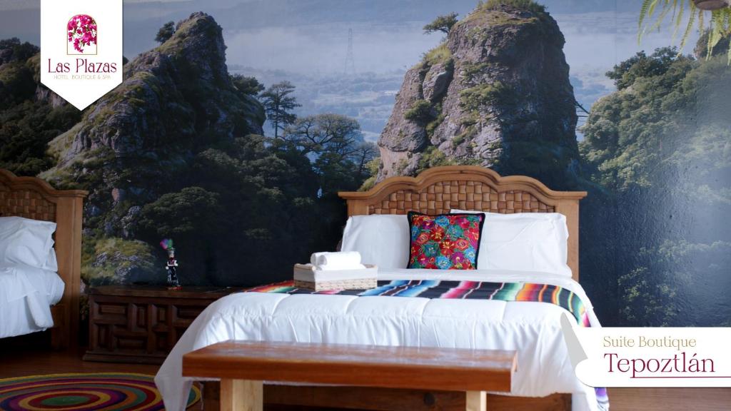 a bedroom with a bed with a mountain mural at Suites Las Plazas in Cuernavaca