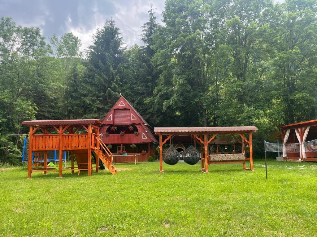 a park with a playground and a house at Cabana Paltini in Costeşti