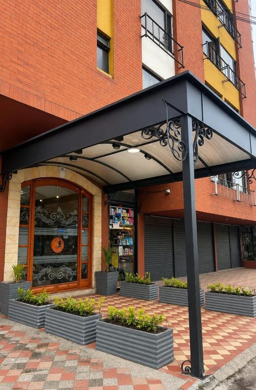 a black umbrella in front of a building at Hostelfc Marly in Bogotá