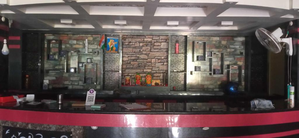 a bar with a stone wall with stained glass at Hotel O Snenanjali in Kolkata