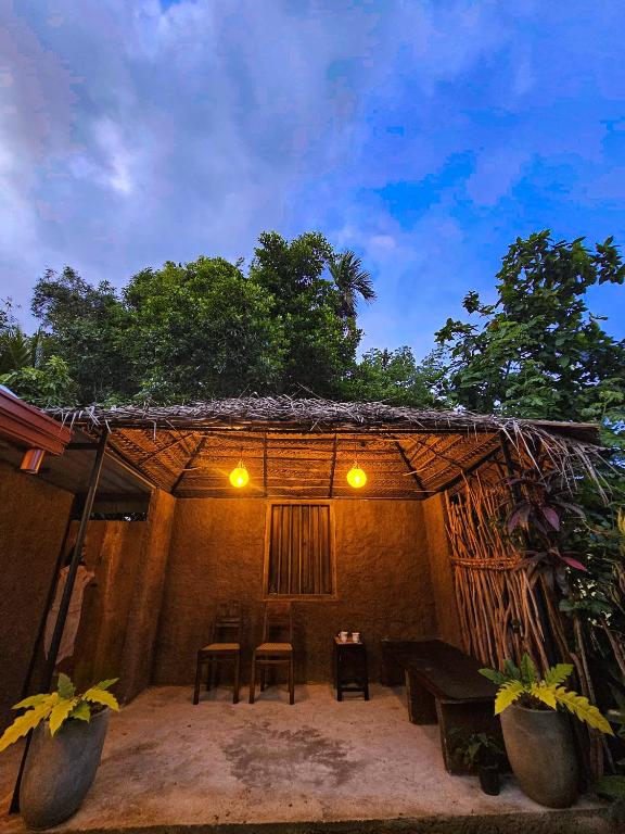 a house with a table and chairs in front of it at Casa Cayena - Tangalle in Tangalle