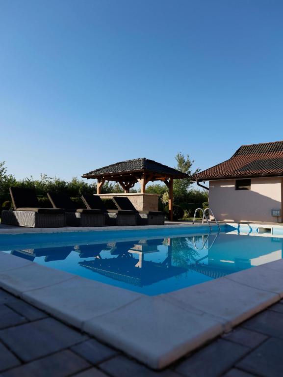 a swimming pool in front of a gazebo at Muzzle House in Knić