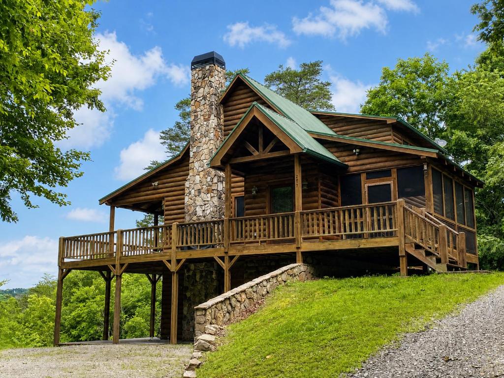 a log cabin with a wrap around deck at Lords View in Mineral Bluff