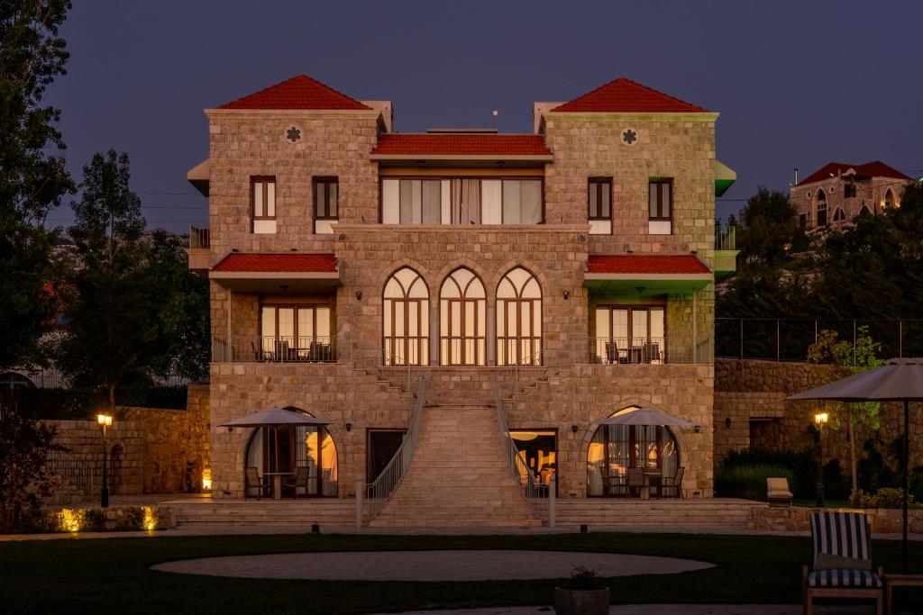 a large brick building at night at Alyasa Village in Jbeil