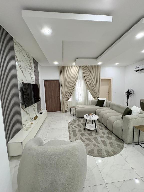 a large living room with a couch and a tv at Executive Apartment in Anthony in Lagos